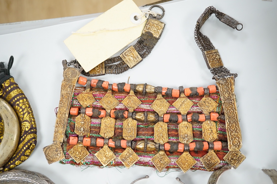 A collection of Bedouin white metal, gilt metal, lapis lazuli mounted jewellery, etc. from Oman